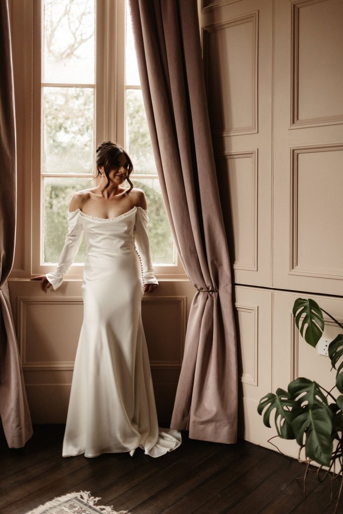 A bride in front of the window at Netherbyres